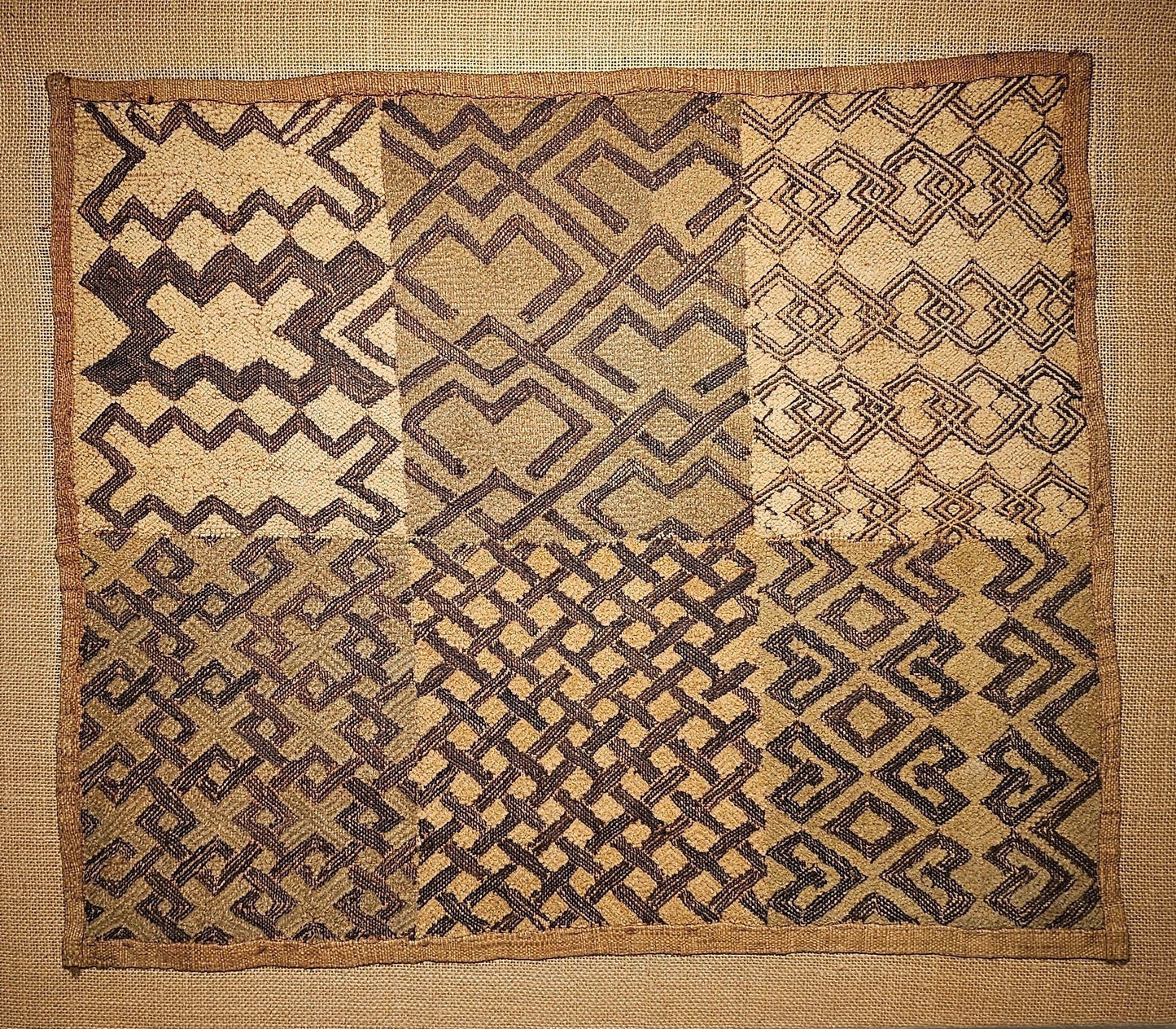 Kuba Textile with geometric pattern on a plain wall - AfrahouseAfrican Art