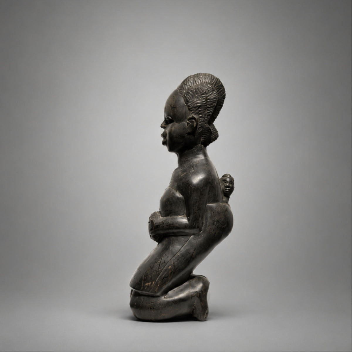 African Sculpture of kneeling mother an child