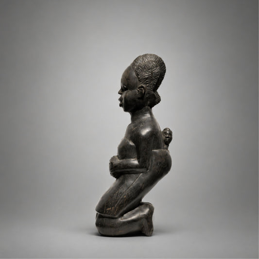 African Sculpture of kneeling mother an child