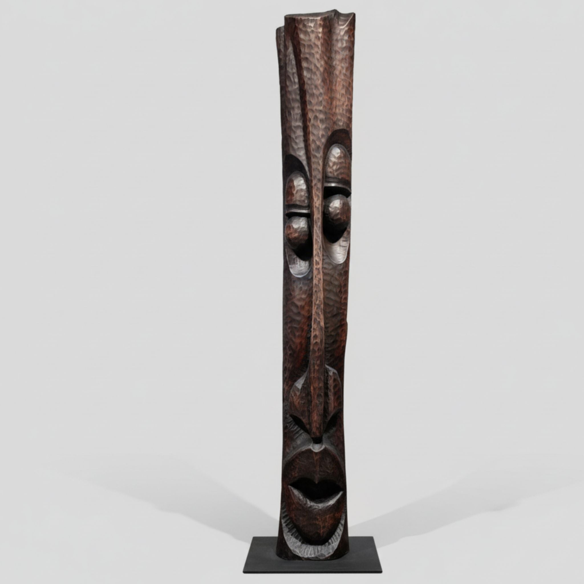 Tall wooden mask on a white background