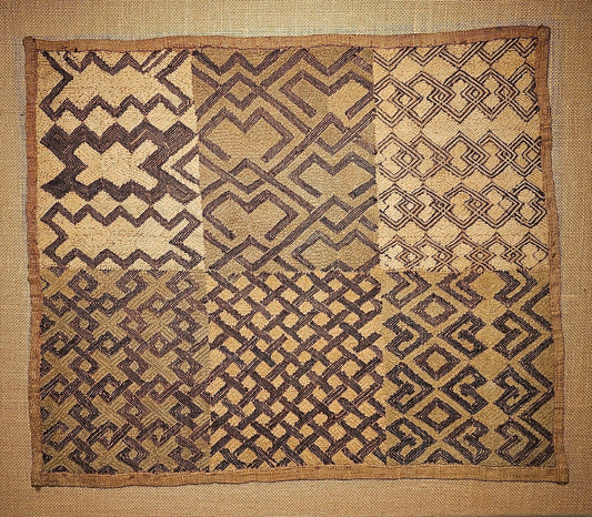 Kuba Textile with geometric pattern on a plain wall - AfrahouseAfrican Art